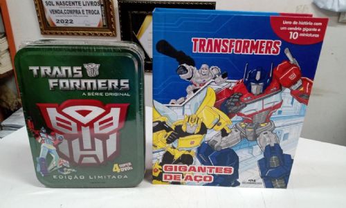Kit Dvd Box Lata - Transformers Desenho c/ 4 Discos + Livro Transformers: Gigantes de Aço c/ Miniatu